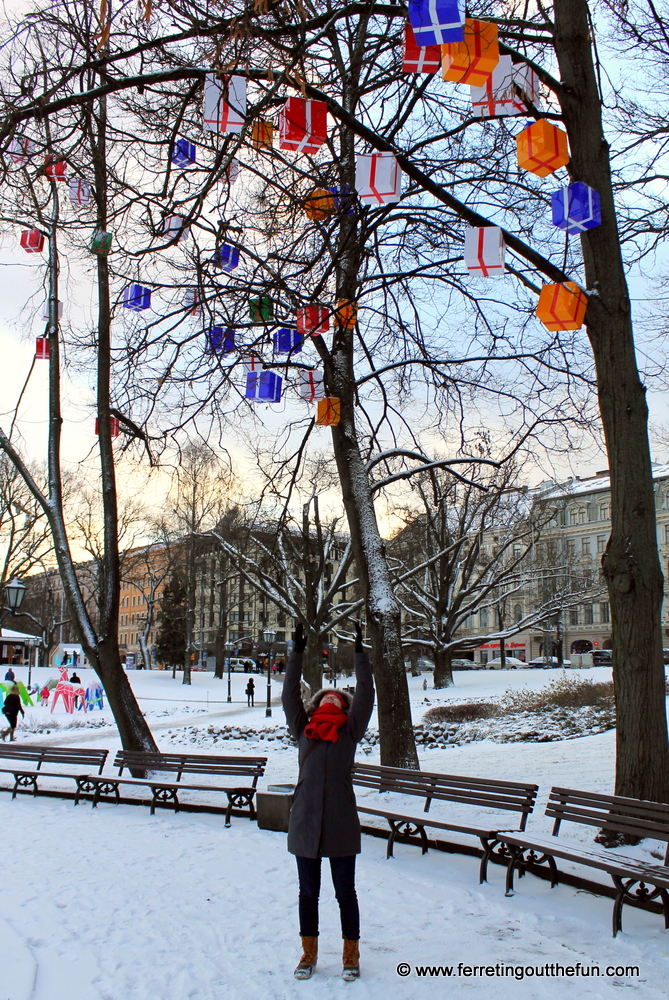 Christmas presents hang from the trees in a snowy Riga, Latvia