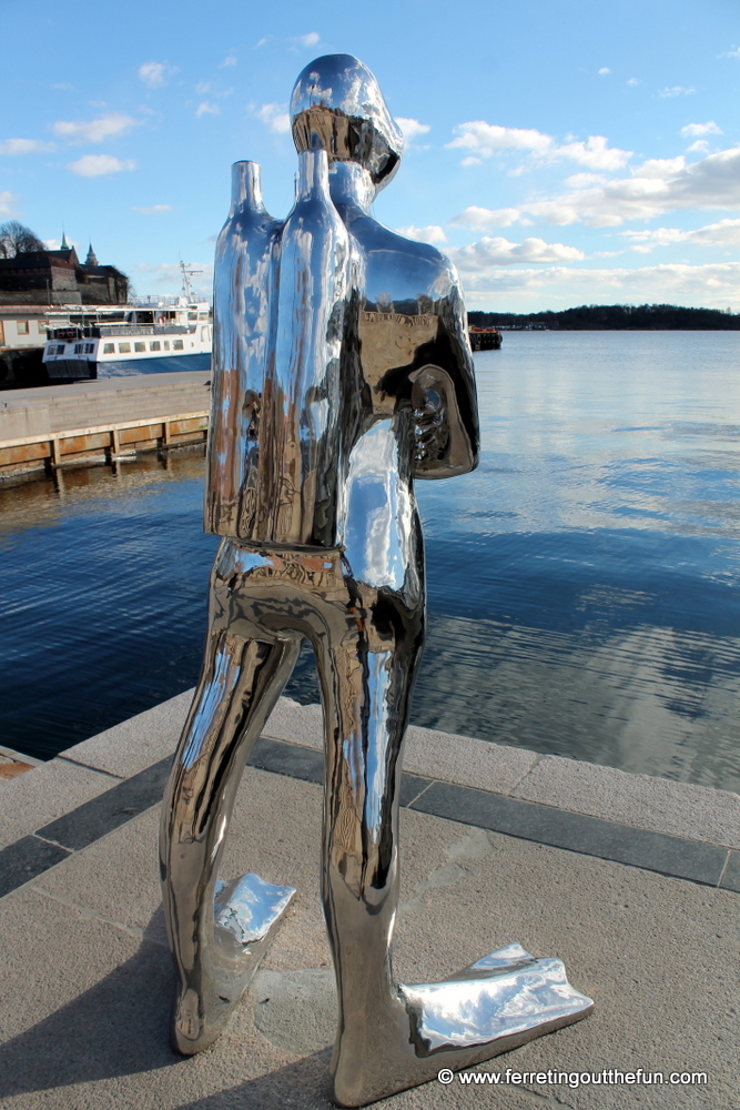 Clouds reflect on the Silver Scuba Diver, a modern sculpture in Oslo, Norway