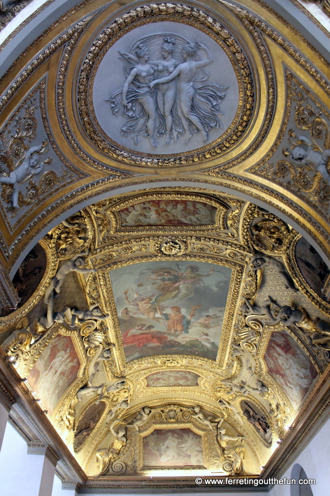 An ornate ceiling inside the Louvre palace in Paris