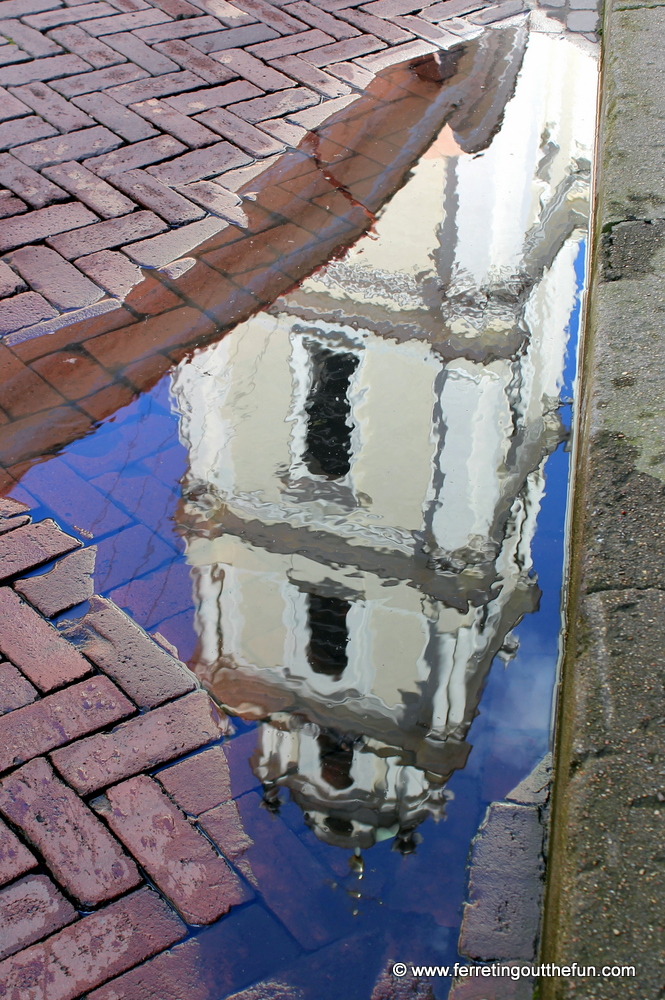 Puddle reflection of a church spire in Vilnius, Lithuania