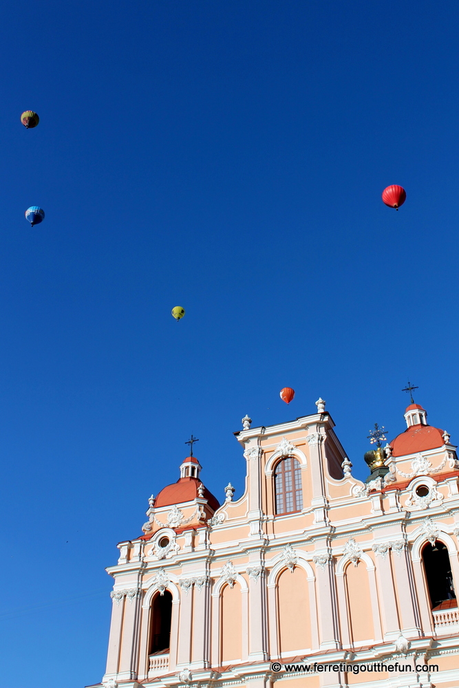 Hot air balloons float above a church in Vilnius, Lithuania