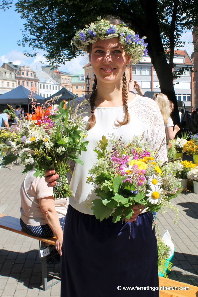 A Latvian woman selling flowers for Ligo