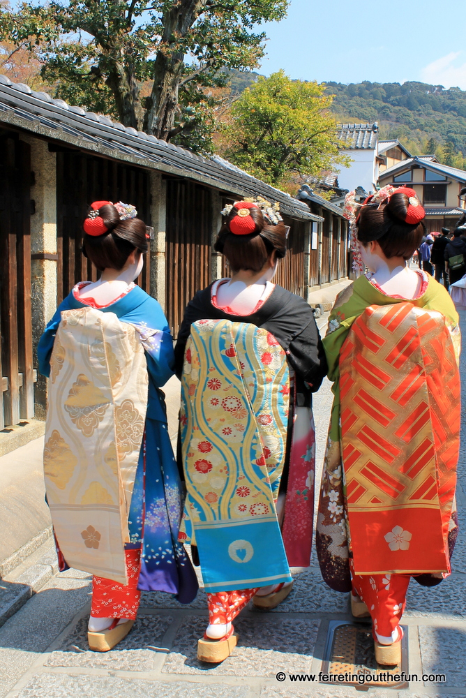 Geisha wearing colorful kimonos stroll through the historic Gion neighborhood of Kyoto, Japan