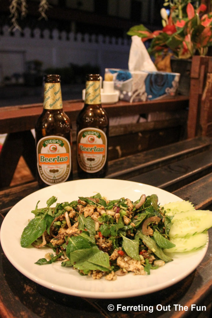 A traditional Lao meal of laap, a spicy chicken salad, and Beerlao in Vientiane