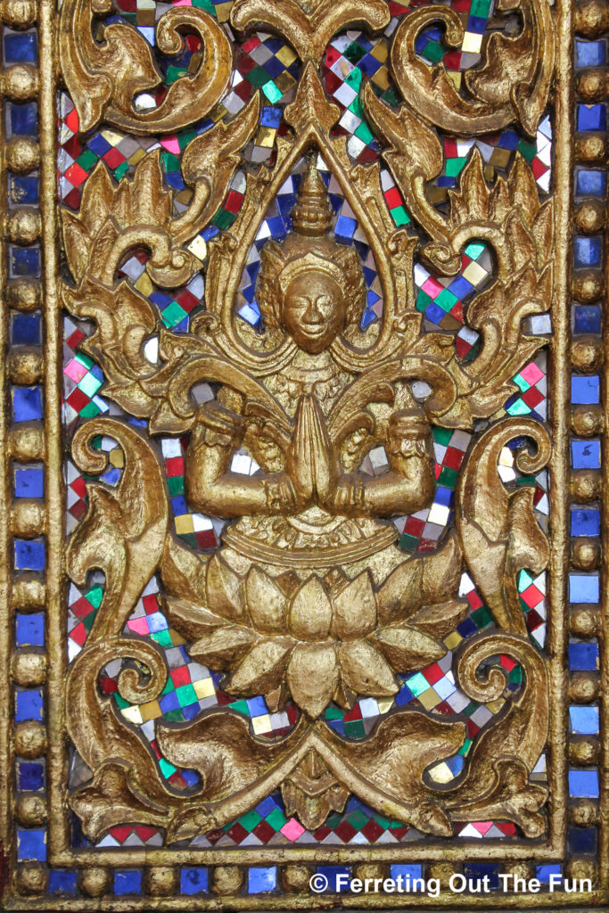 Glass and gold mosaic at a Buddhist temple in Vientiane, Laos