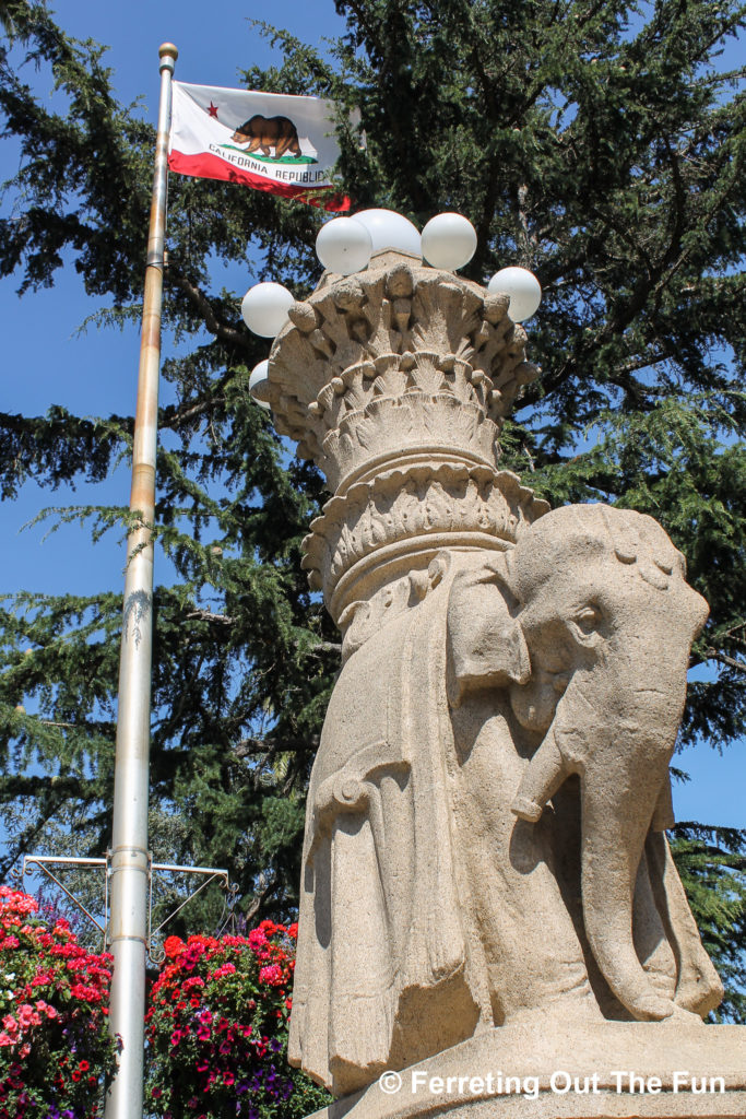 The Califlornia flag flies over a stone elephant lamp in Sausalito, California