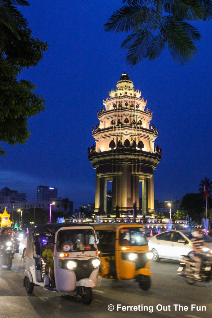 Traffic zips round the Independence Monument at night in Phnom Penh, Cambodia