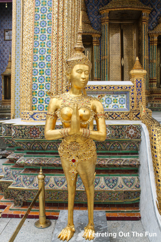A golden figure greets visitors to Wat Phra Kaew the Temple of the Emerald Buddha, at the Grand Palace Bangkok