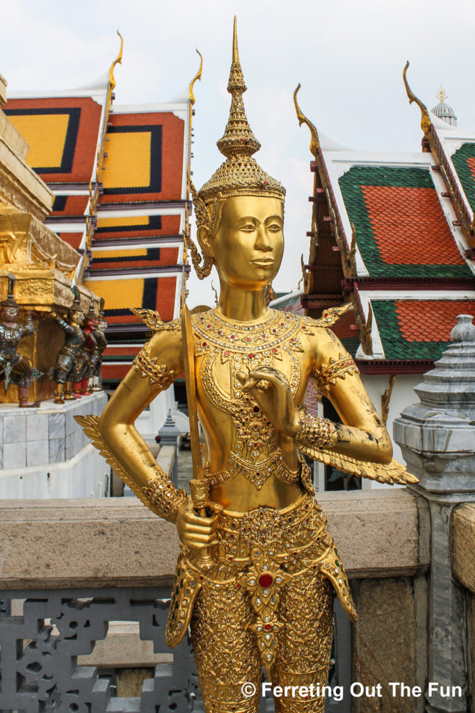 A golden statue stands guard at Wat Phra Kaew in Bangkok