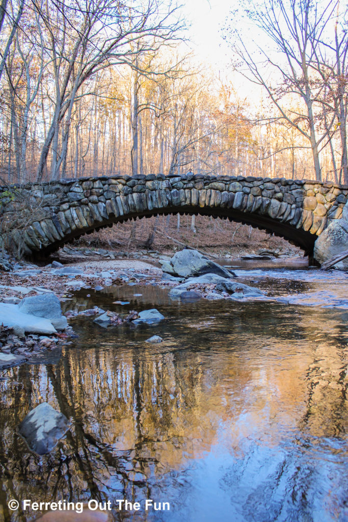 An old stone bridge crosses a stream in Rock Creek Park in Washington DC