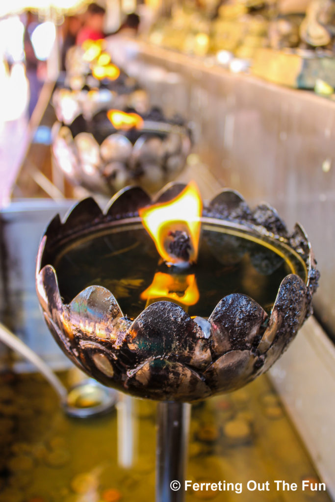 Burning candles at Wat Doi Suthep, one of the most important Buddhist temples in Chiang Mai, Thailand