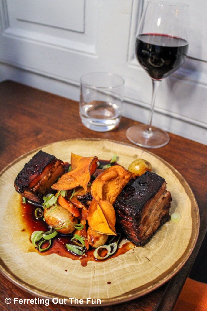 Pork belly confit with root vegetables and cider sauce at Bistrotters, one of the best places to eat in Paris