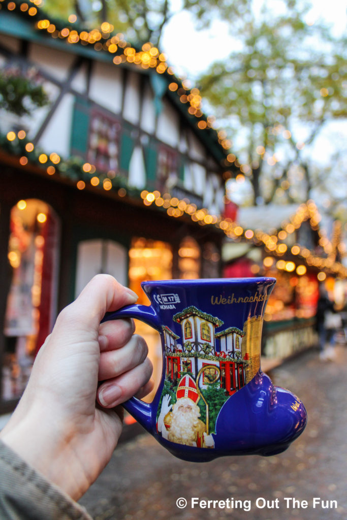 Charming blue boot gluhwein mugs at Nicholas Village, part of the Cologne Christmas Market