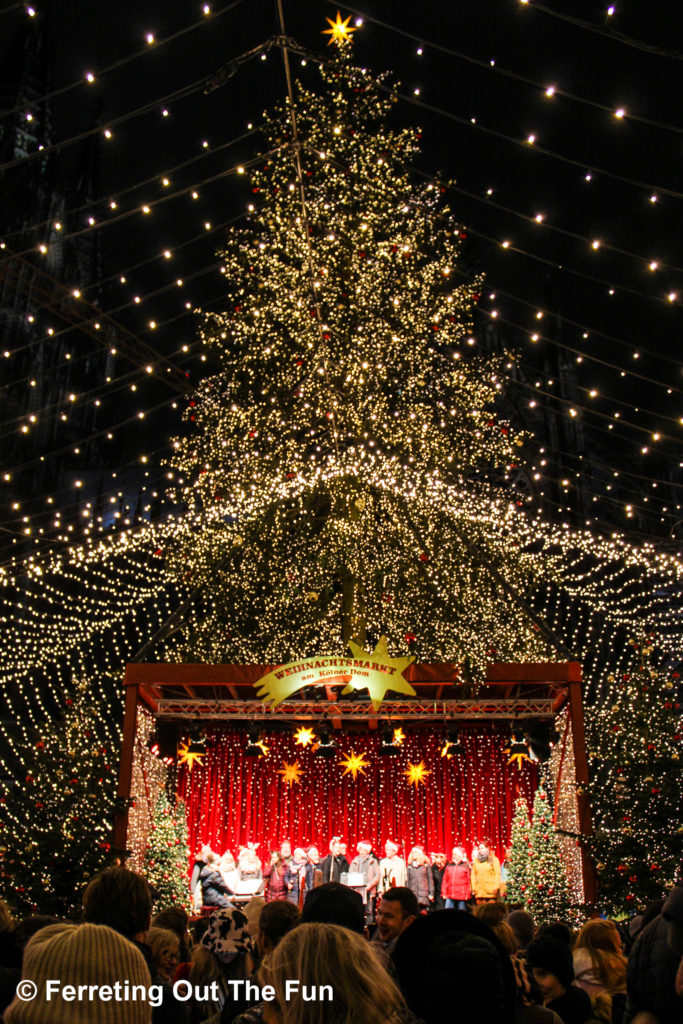 Carolers perform on stage at the Cologne Christmas Market in Germany