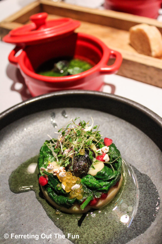 Snails with herb butter and warm spinach salad. Elevated Austrian cuisine at Gruber's Restaurant in Cologne.