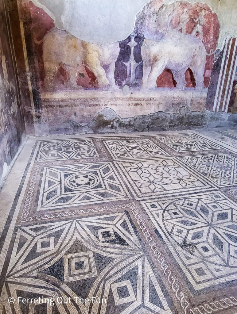 Detailed mosaic floor and the remains of a fresco with elephants in Pompeii, Italy