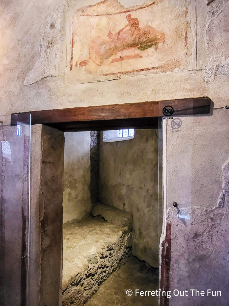 An erotic fresco hangs above a bedroom door in the Pompeii Lupanare, or brothel