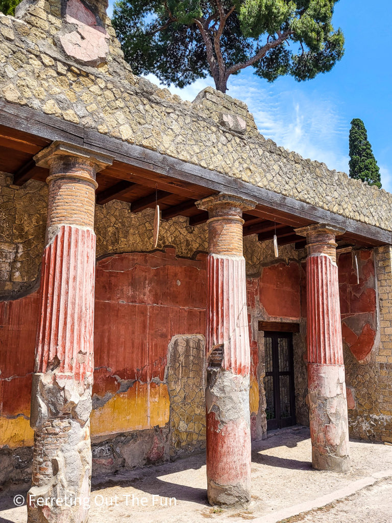 Colorful red columns of a ruined villa at the Herculaneum UNESCO Site