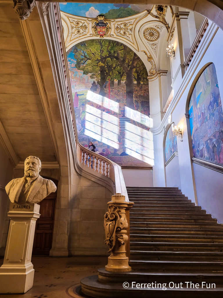 A grand staircase leads up to the beautifully painted public halls of Toulouse City Hall, France
