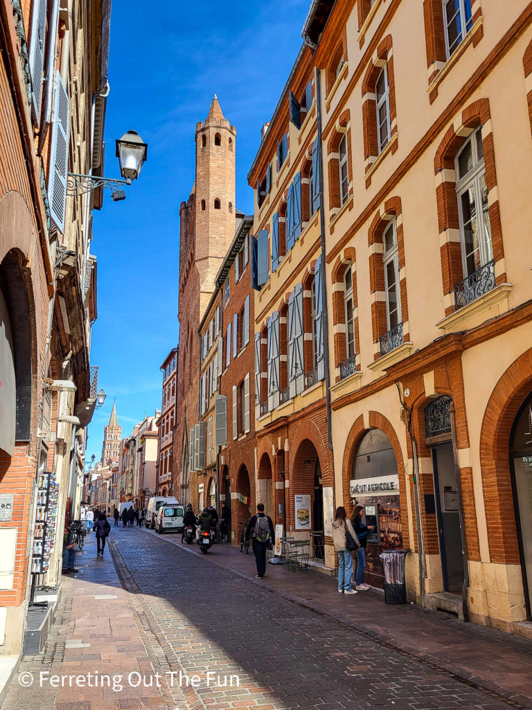Walking down a cobbled street in Toulouse. It's known as France's Pink City because of the distinctive red bricks used in many buildings.