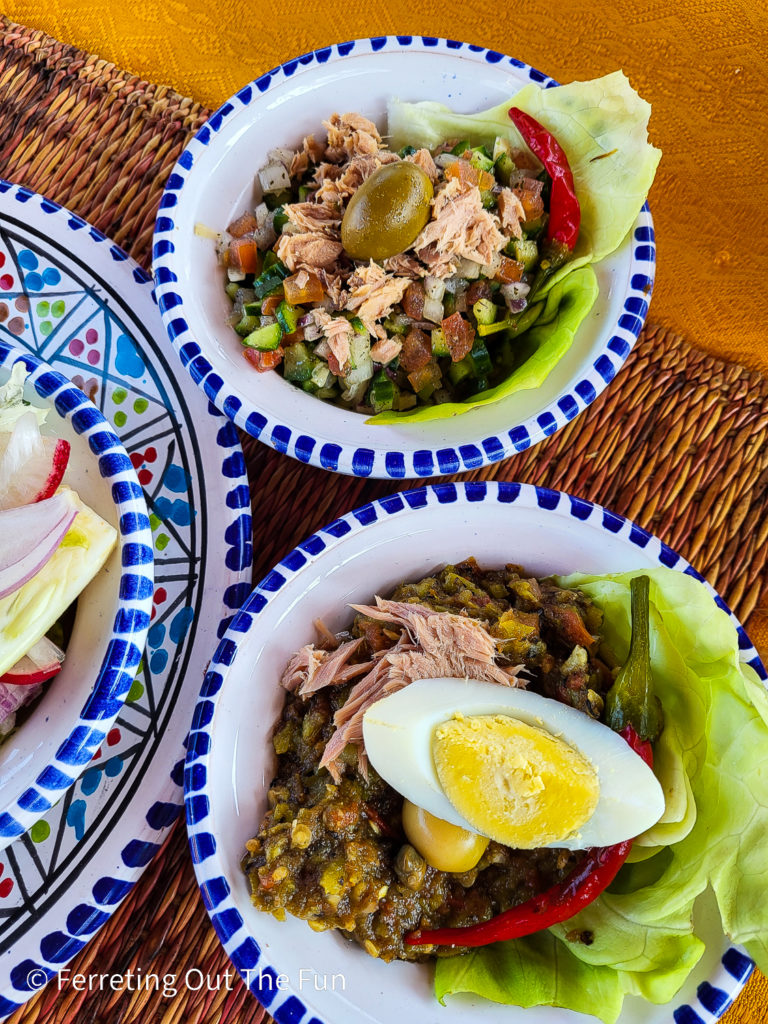 A highlight of Tunisian cuisine is the fresh salads at the beginning of a meal. They typically include a refreshing cucumber-tomato salad and mechouia salad with spicy peppers. Most salads in Tunisia are topped with canned tuna, olives, and egg.