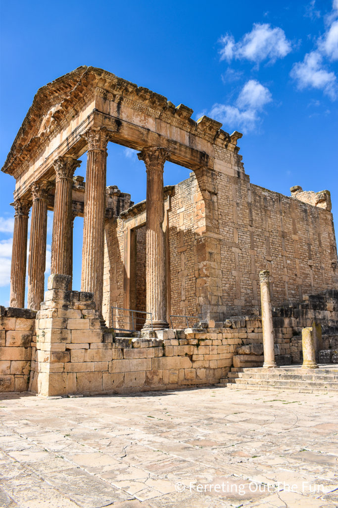 The impressive Temple of Jupiter in Dougga Tunisia, one of the best-preserved Roman towns in Africa. A compass of the 12 winds is visible in the stone plaza next to the temple.