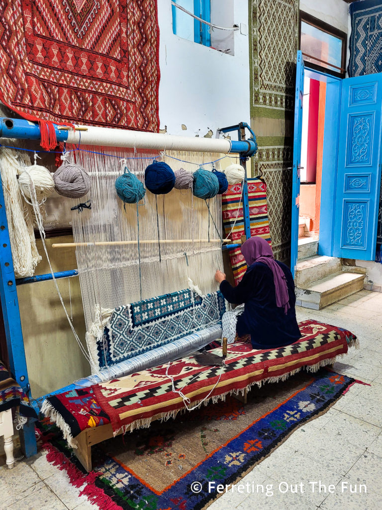 A Tunisian woman weaves a carpet in Kairouan, Tunisia