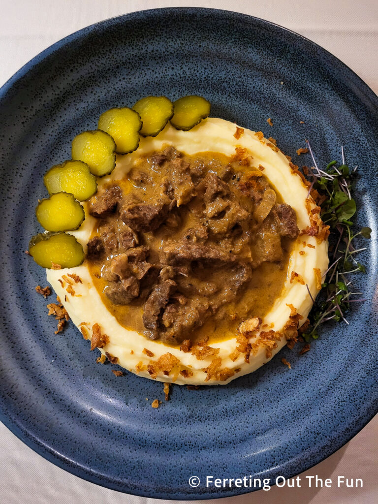 Beef stroganoff with pickles, crispy onions and mashed potatoes at Uncle Vanya restaurant in Riga