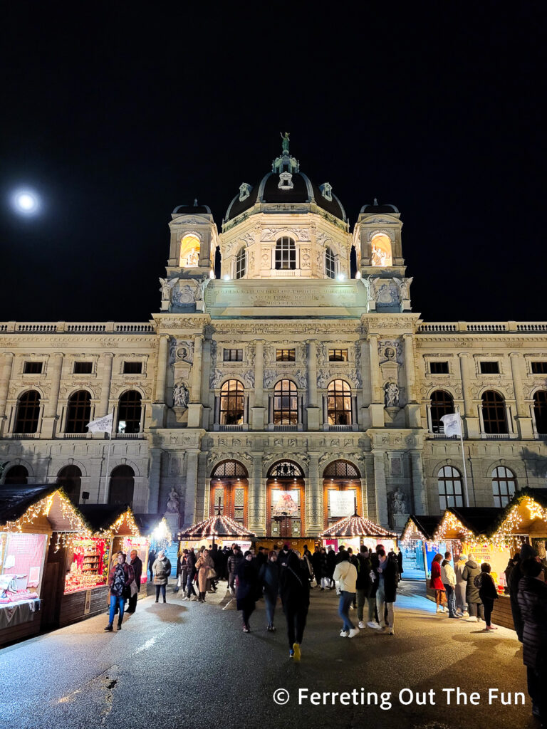 The moon rises over Maria Theresien Platz Christmas Village in Vienna