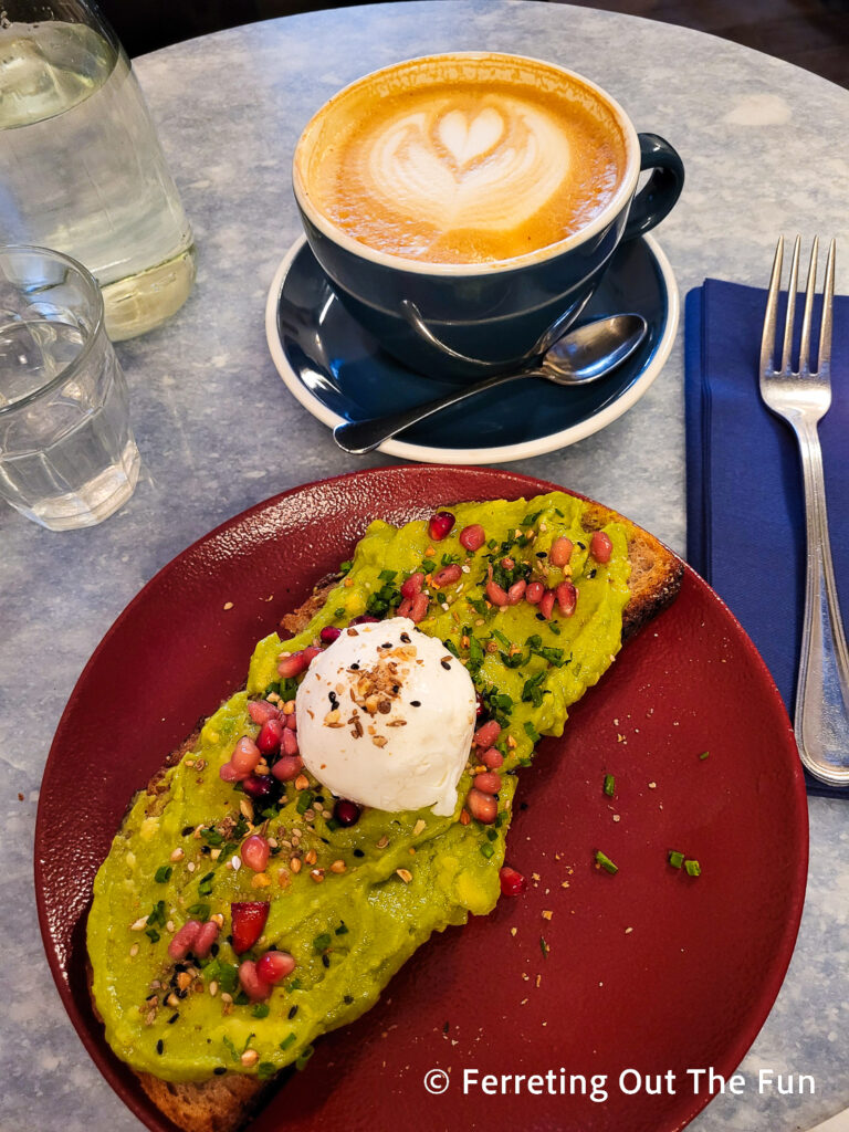 Avocado toast with a poached egg and pomegranate seeds at Kozy Bosquet Cafe Paris